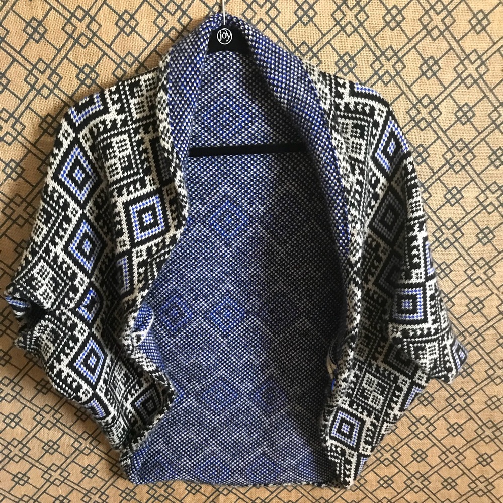 Cape throw on sweater